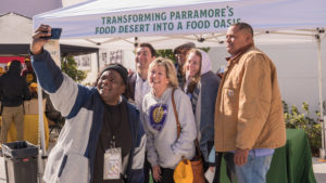 A photo of community members in Orlando, FL, working on relieving food deserts.