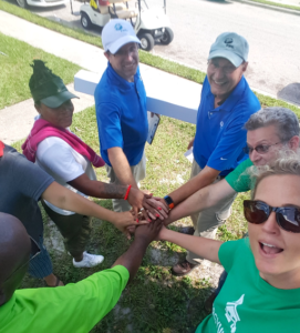 Members of the community huddle together. Sustainability best practices rely on input from local communities.