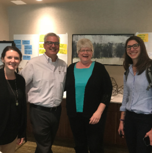 Four community members smiling for the camera after discussing community building for sustainability.