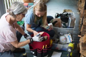 Alice and Yulia with supplies demonstrating weatherization and energy efficiency upgrades in Asheville and Buncombe County, North Carolina.