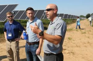 NWA Democrat-Gazette/DAVID GOTTSCHALK Matt Irving (right), vice president of operations at Today's Power, describes Friday the new solar array at the Westside Wastewater Treatment Plant following a flipping the switch ceremony in Fayetteville. Fayetteville, Ozarks Electric Cooperative and Today's Power partnered to bring the 10-megawatt solar system with 24 megawatt-hours of on-site energy storage to the city's two wastewater treatment plants.