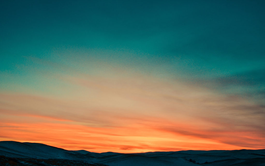 A photo of a beautiful blue violet orange sunset over mountains signifying Southeast Sustainability Directors Network (SSDN) about