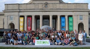 large group of people with SSDN banner
