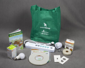 green cloth bag surrounded by several items for an energy efficiency kit