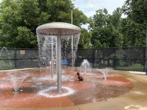Child playing in outdoor splashpad