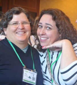 Two women standing together smiling