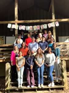 Group of people pose on staircase