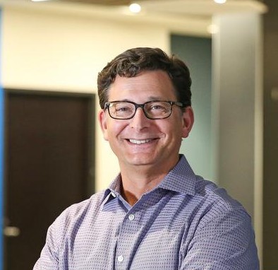 man with dark hair and glasses
