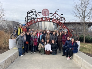 group of people standing under a sign