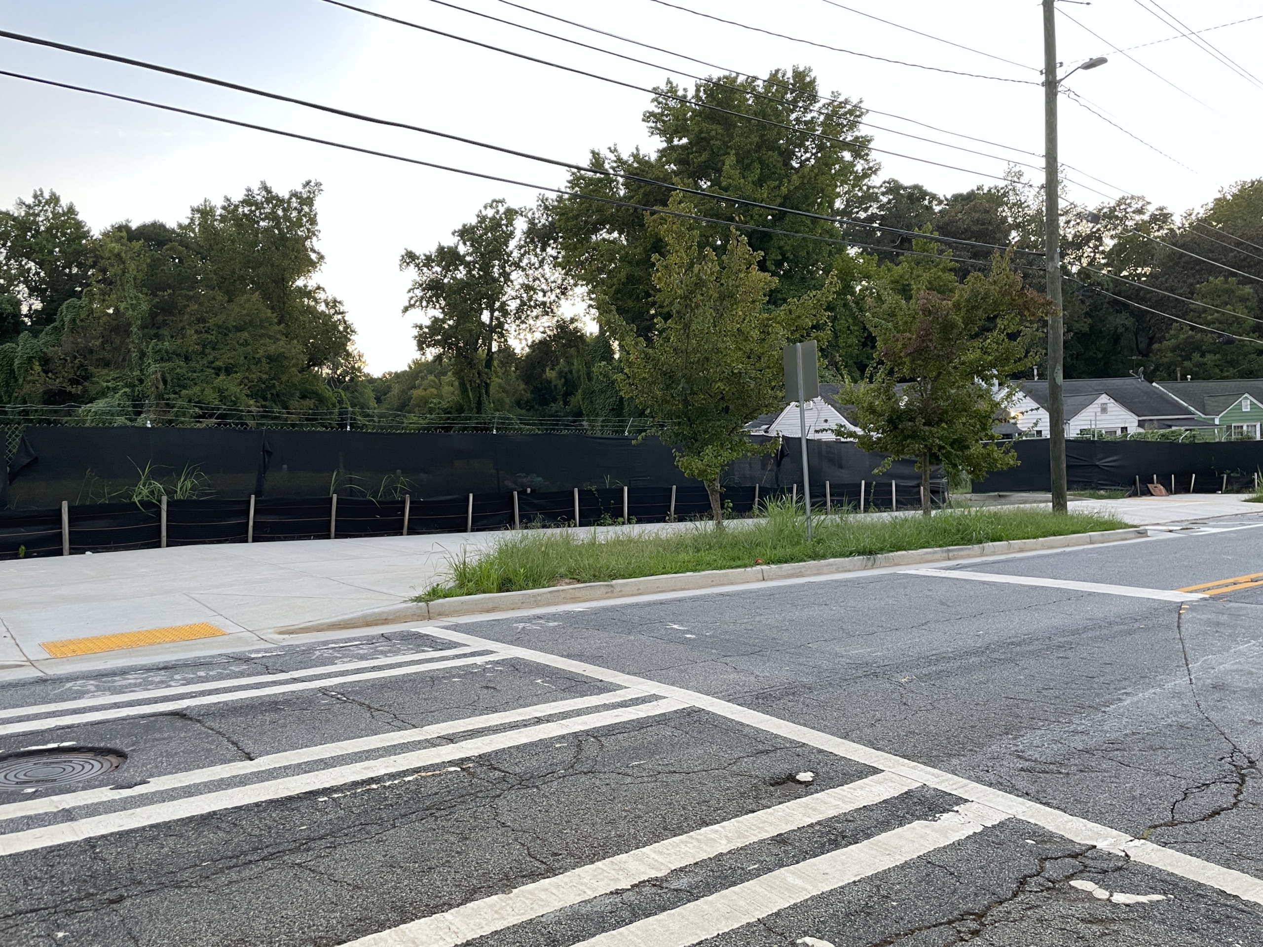 cross walk with trees and powerlines in background