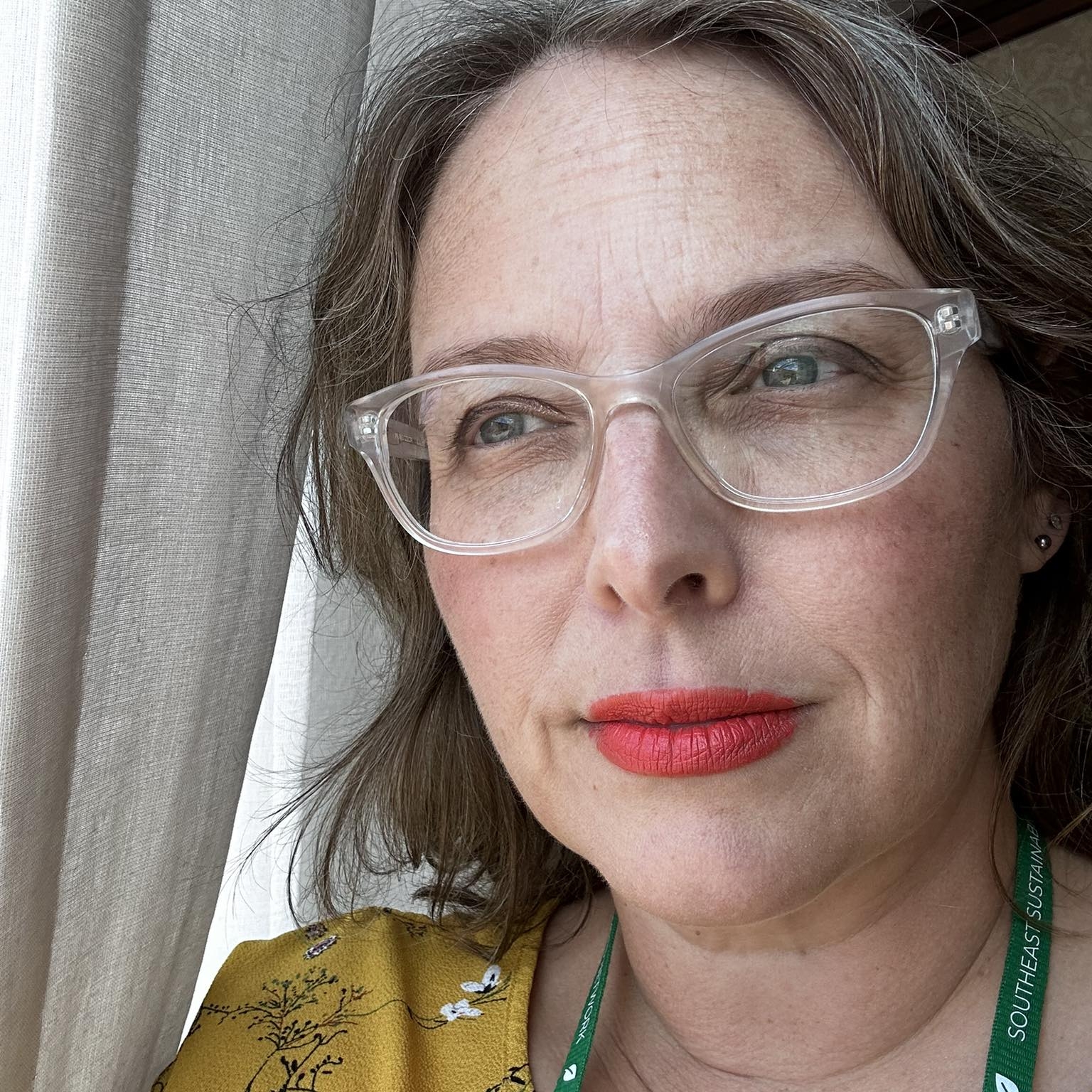 woman in yellow shirt and glasses