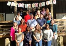 Group of people pose on staircase