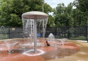 Child playing in outdoor splashpad